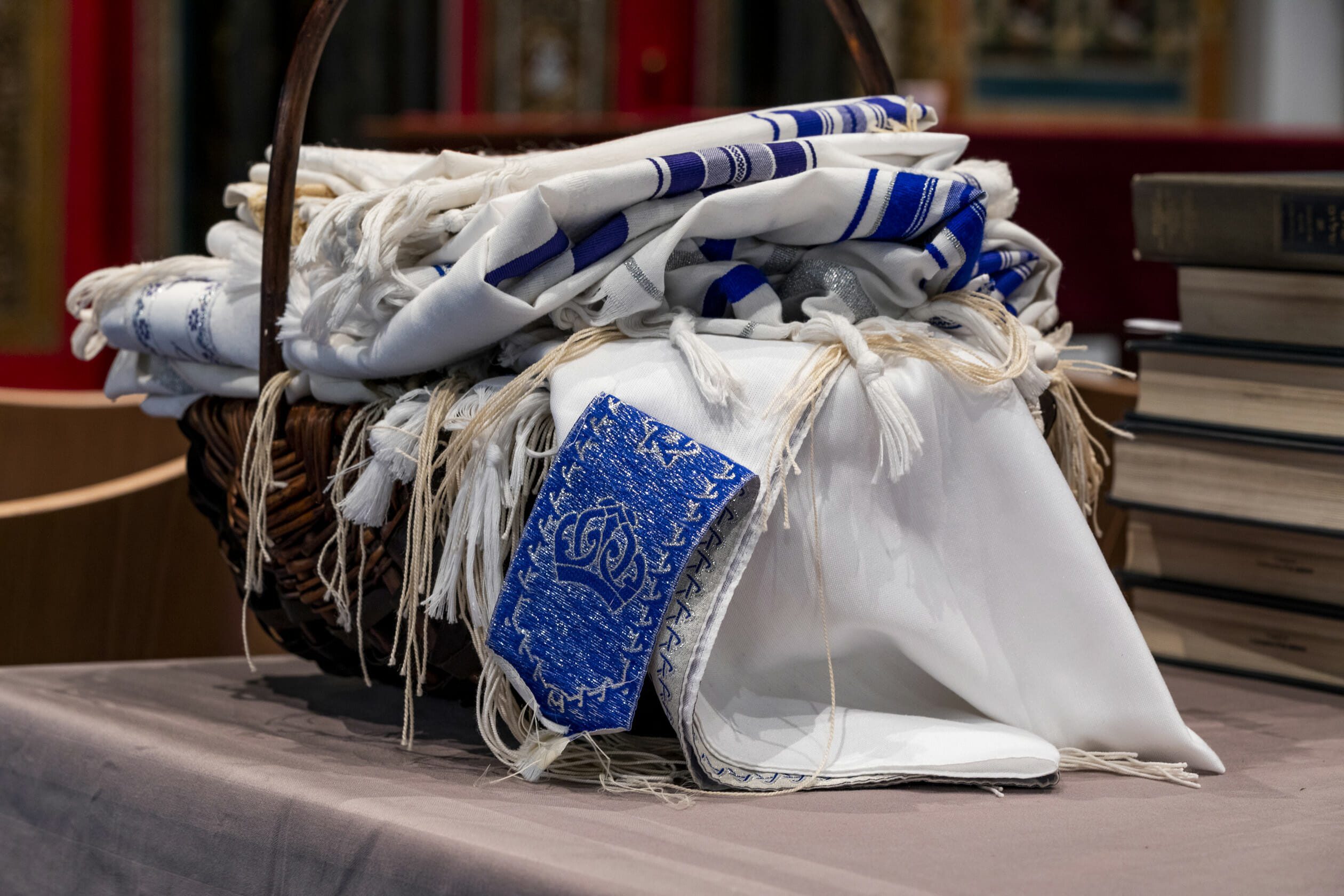 blue and white tallitot in a basket
