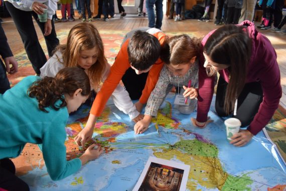 kids using large map at family fun night